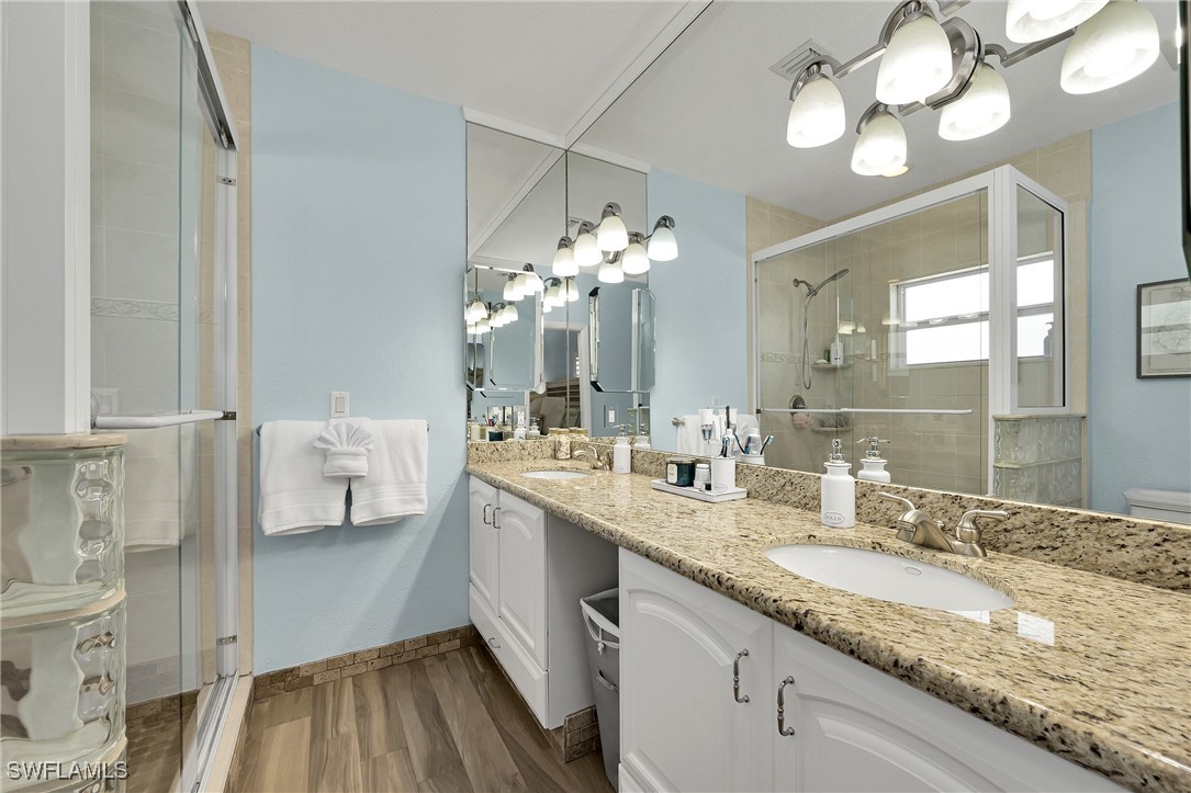 189 Gulfview Drive Islamorada, FL 33036 - Photo 35 of 49 a bathroom with a granite countertop sink a toilet and a mirror