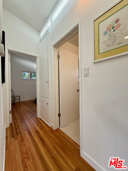 5128 East Wardlow Road Long Beach, CA 90808 - Photo 11 of 35 a view of a hallway with wooden floor and closet