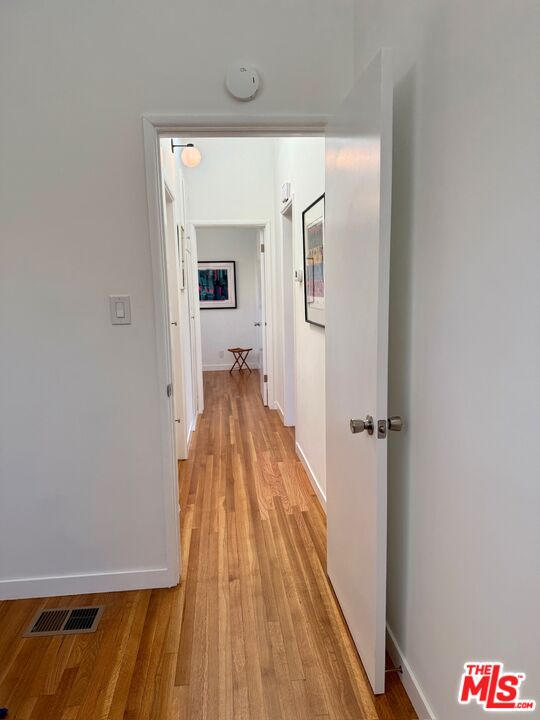 5128 East Wardlow Road Long Beach, CA 90808 - Photo 16 of 35 a view of a hallway with wooden floor