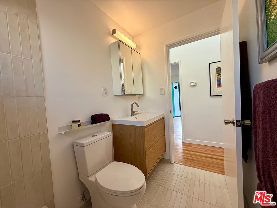 5128 East Wardlow Road Long Beach, CA 90808 - Photo 18 of 35 a white toilet sitting next to a bathroom sink