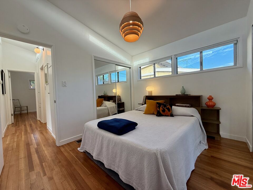 5128 East Wardlow Road Long Beach, CA 90808 - Photo 20 of 35 a bedroom with bed and wooden floor