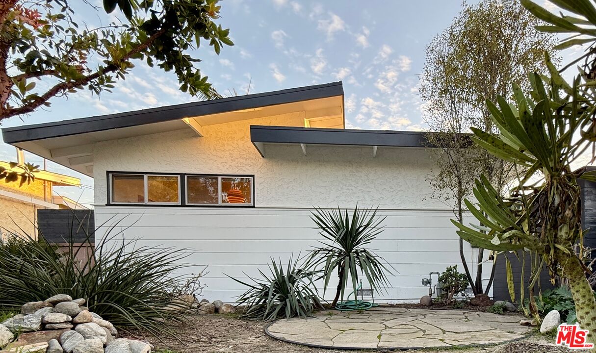 5128 East Wardlow Road Long Beach, CA 90808 - Photo 2 of 35 a front view of a house with a tree