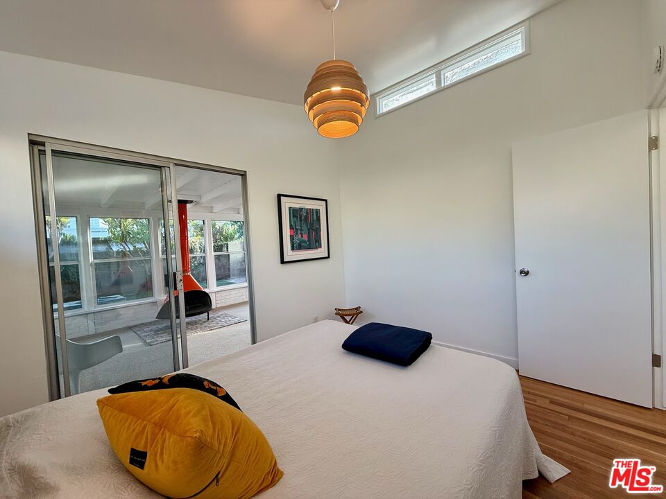 5128 East Wardlow Road Long Beach, CA 90808 - Photo 22 of 35 a bedroom with a bed and a window