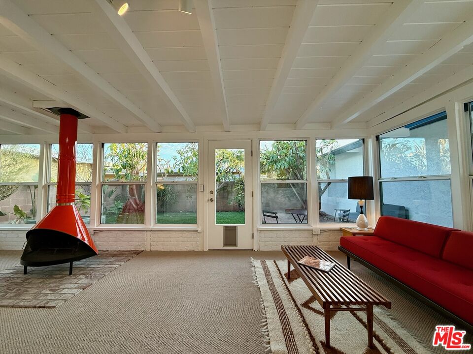 5128 East Wardlow Road Long Beach, CA 90808 - Photo 24 of 35 a living room with a large window and a table