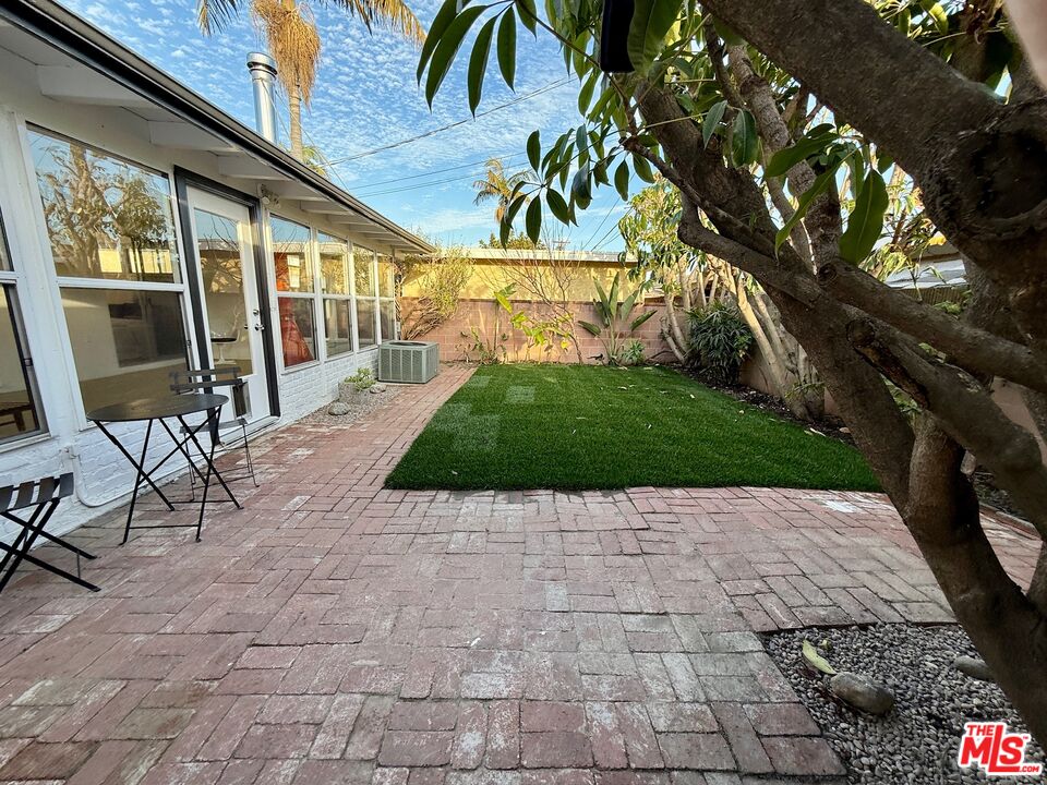 5128 East Wardlow Road Long Beach, CA 90808 - Photo 27 of 35 a view of backyard with table and chairs and potted plants