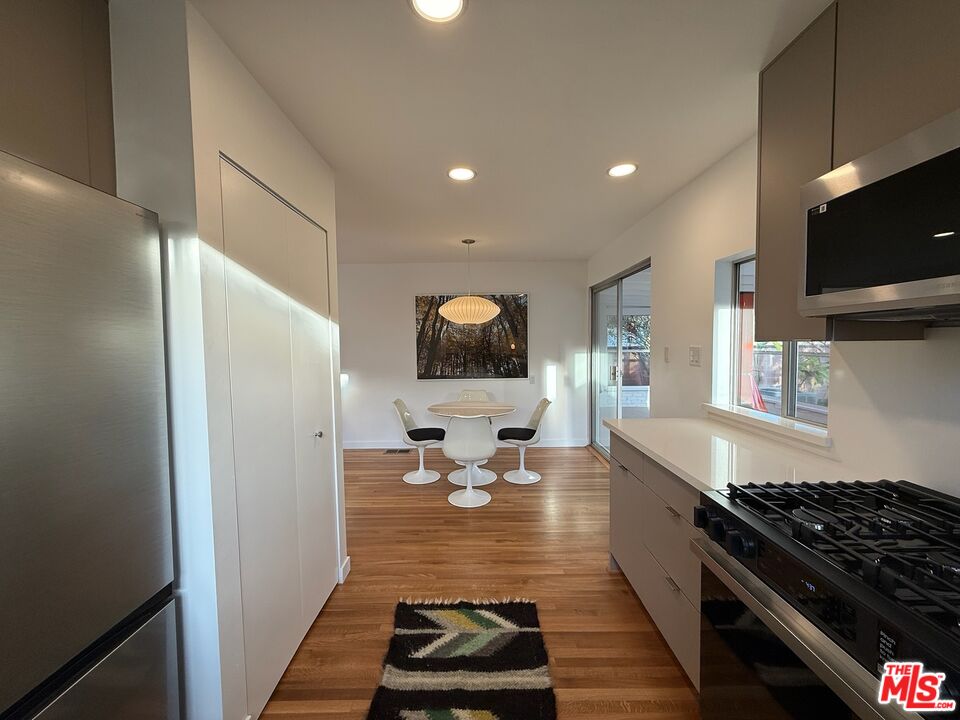 5128 East Wardlow Road Long Beach, CA 90808 - Photo 6 of 35 a kitchen with a sink and a stove top oven