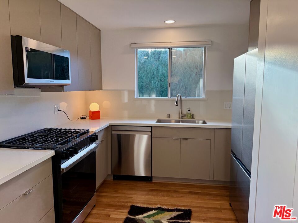 5128 East Wardlow Road Long Beach, CA 90808 - Photo 8 of 35 a kitchen with a sink stove and microwave