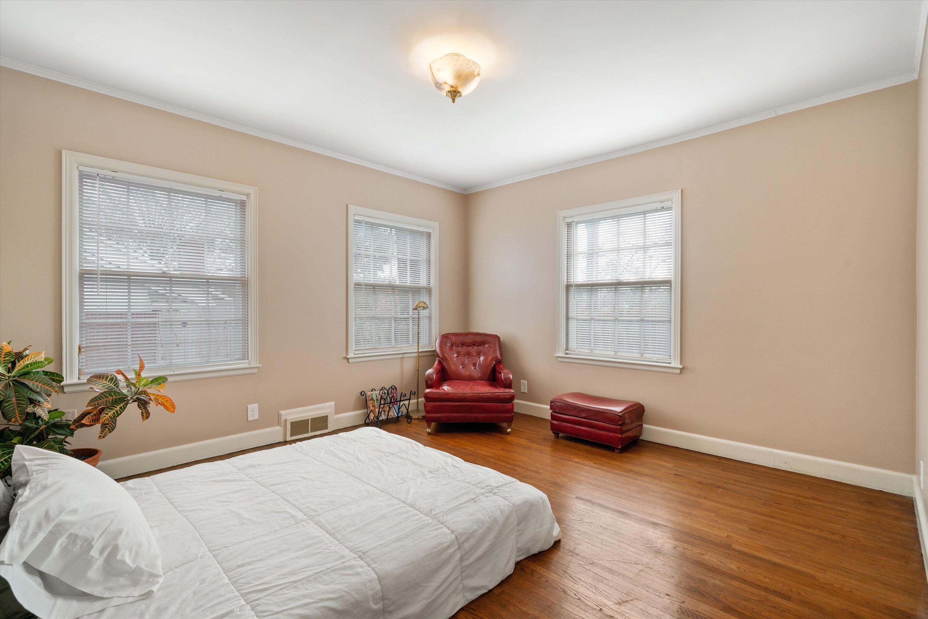 3425 Walnut Grove Road Memphis, TN 38111 - Photo 19 of 25 a bedroom with a bed and wooden floor