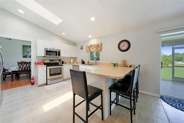 a view of a dining room with furniture and a kitchen