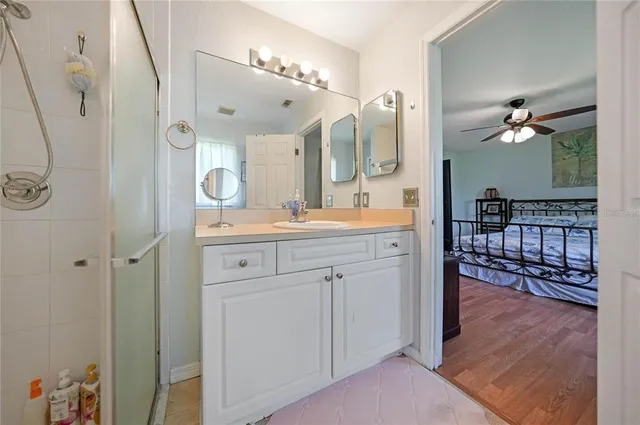 a spacious bathroom with a double vanity sink and a mirror