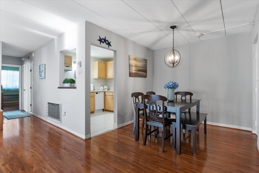 40 High Street, Unit 207 Dedham, MA 02026 - Photo 15 of 41 a view of a dining room with furniture and wooden floor