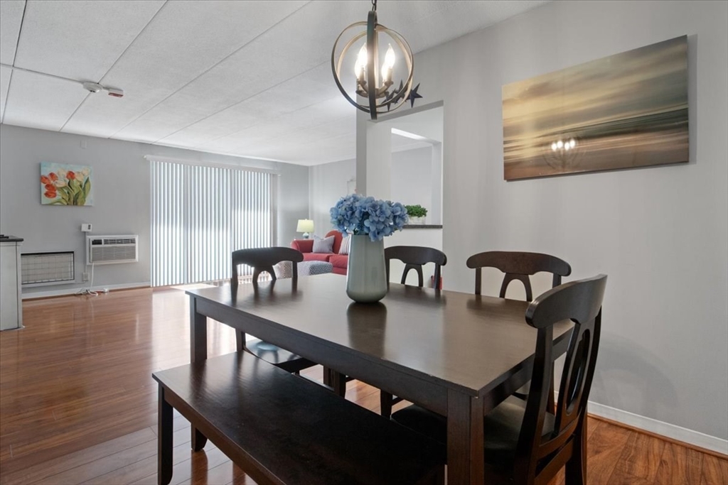 40 High Street, Unit 207 Dedham, MA 02026 - Photo 16 of 41 a view of a dining room with furniture a chandelier and wooden floor