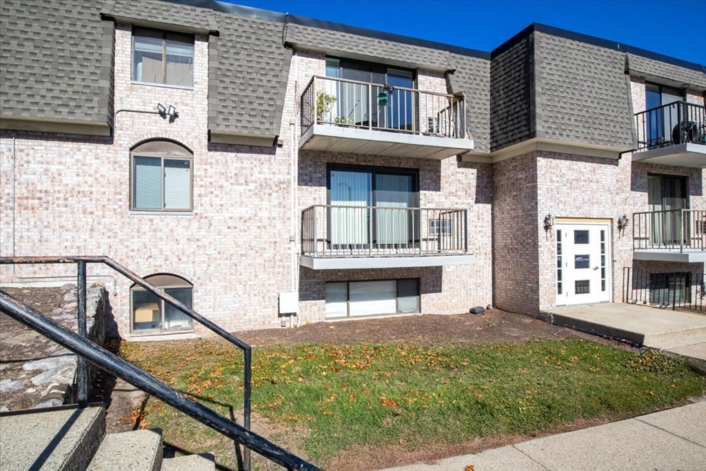 40 High Street, Unit 207 Dedham, MA 02026 - Photo 2 of 41 a view of a house with more windows and wooden fence