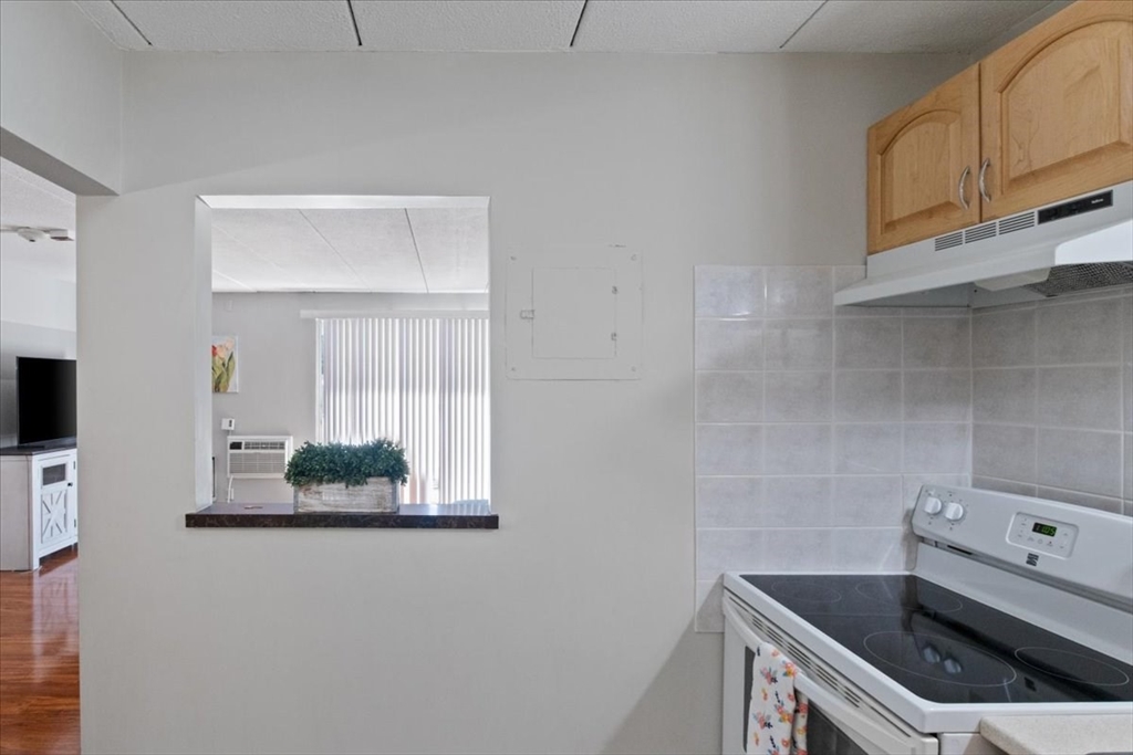 40 High Street, Unit 207 Dedham, MA 02026 - Photo 21 of 41 a kitchen with a sink and cabinets