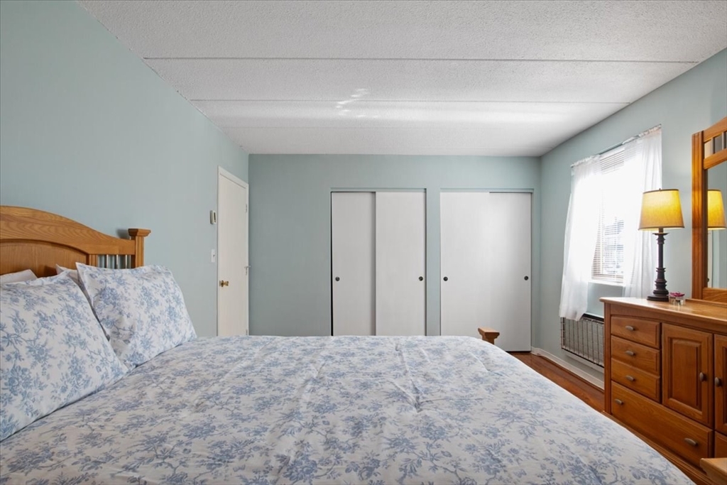 40 High Street, Unit 207 Dedham, MA 02026 - Photo 29 of 41 a bedroom with a bed and a sink