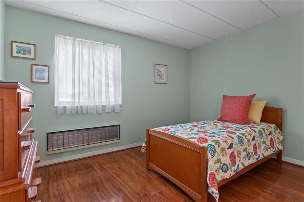 40 High Street, Unit 207 Dedham, MA 02026 - Photo 30 of 41 a bedroom with a bed a flat screen tv and windows