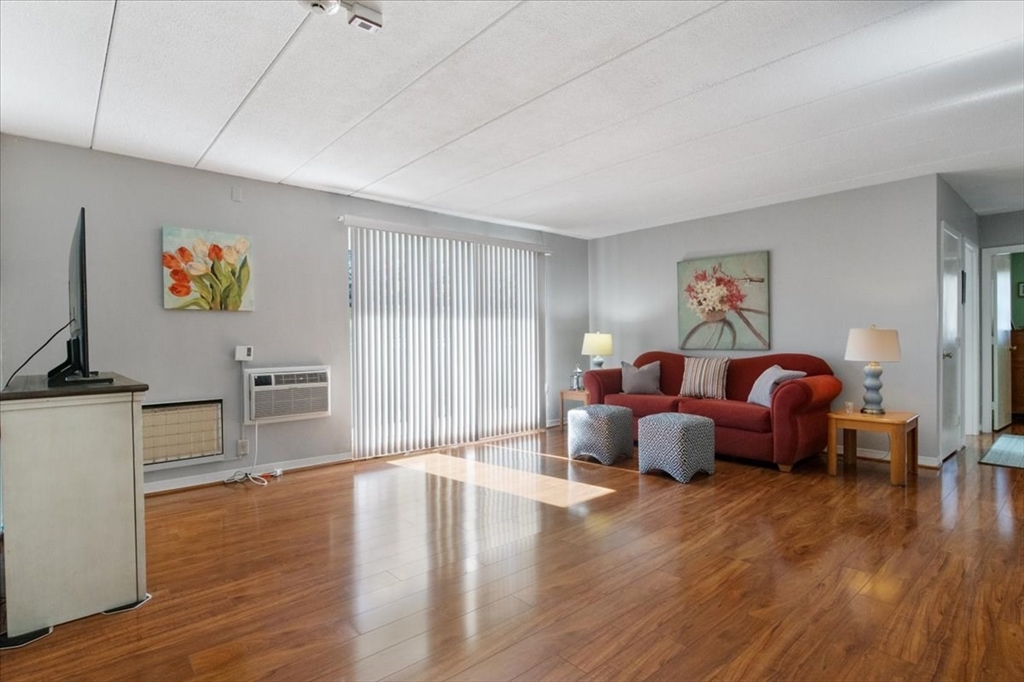 40 High Street, Unit 207 Dedham, MA 02026 - Photo 7 of 41 a living room with furniture and a flat screen tv
