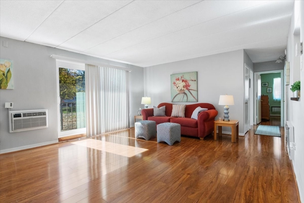 40 High Street, Unit 207 Dedham, MA 02026 - Photo 8 of 41 a living room with furniture and wooden floor