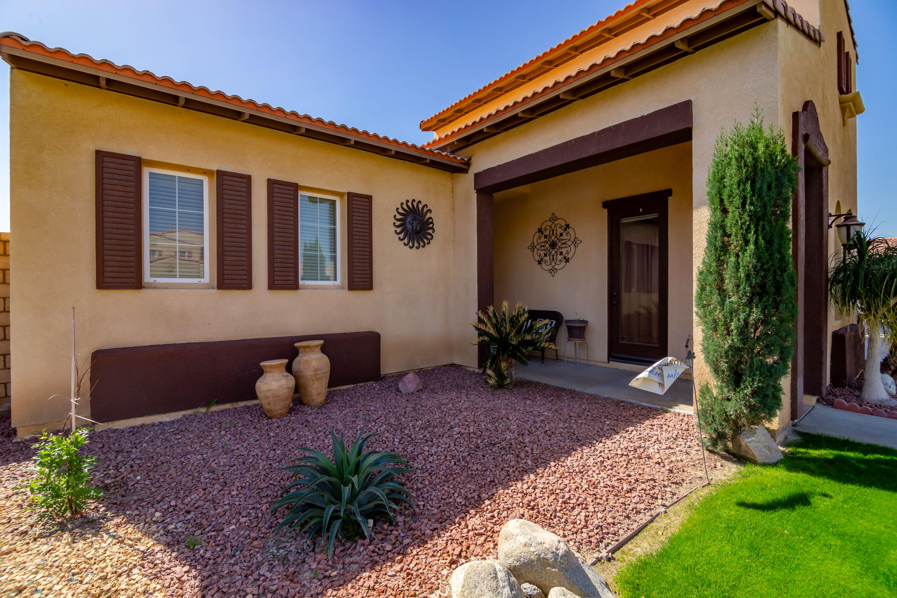 82773 Mount Riley Drive Indio, CA 92203 - Photo 3 of 30 a front view of a house with garden