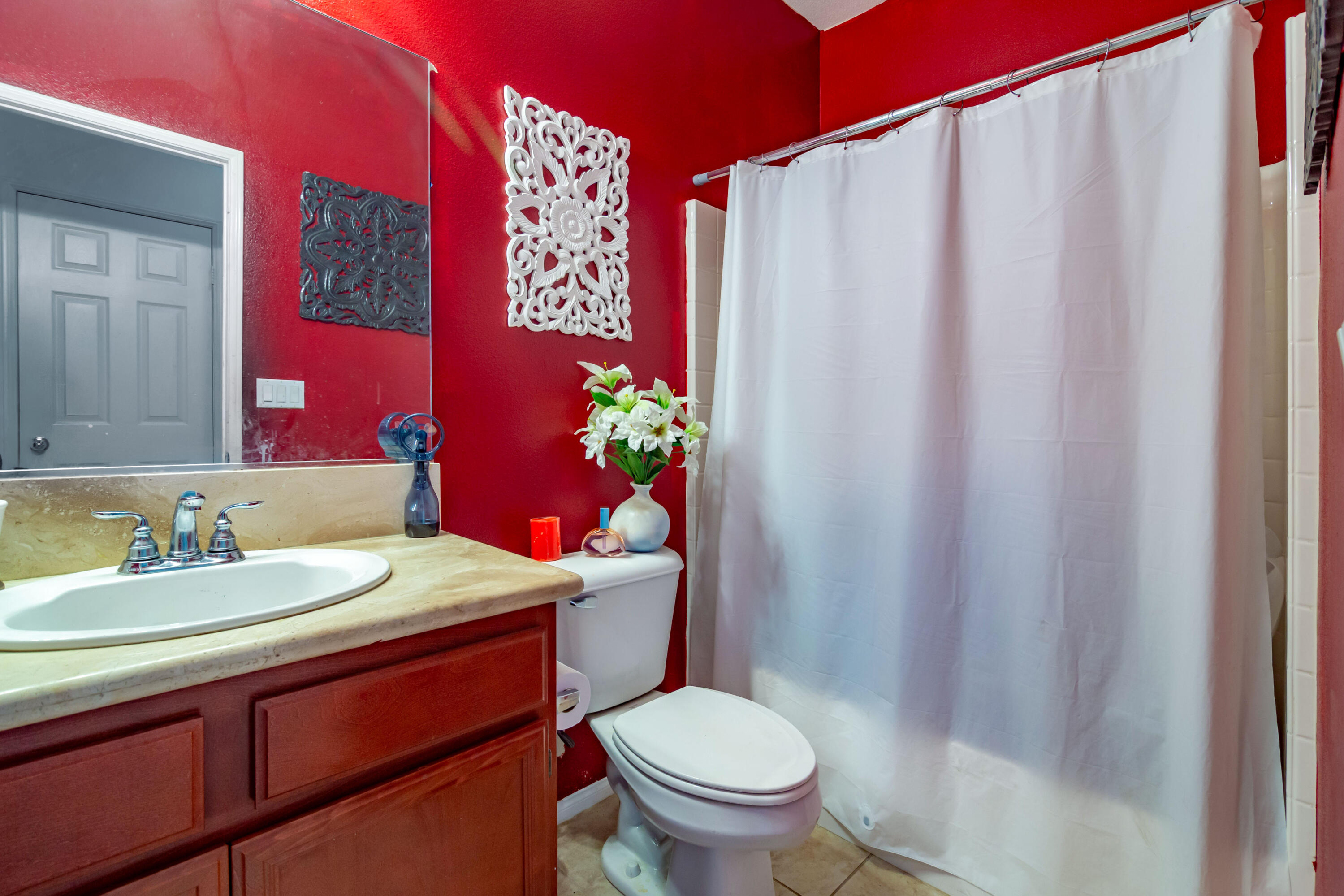 82773 Mount Riley Drive Indio, CA 92203 - Photo 8 of 30 a bathroom with a sink a toilet and shower curtain