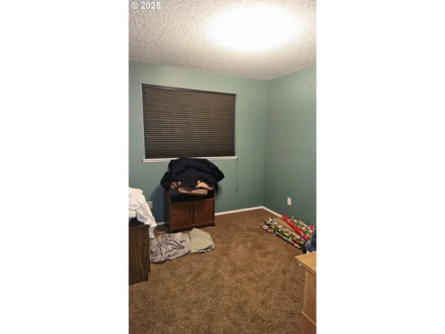 a view of kids room with a floor to ceiling window and storage