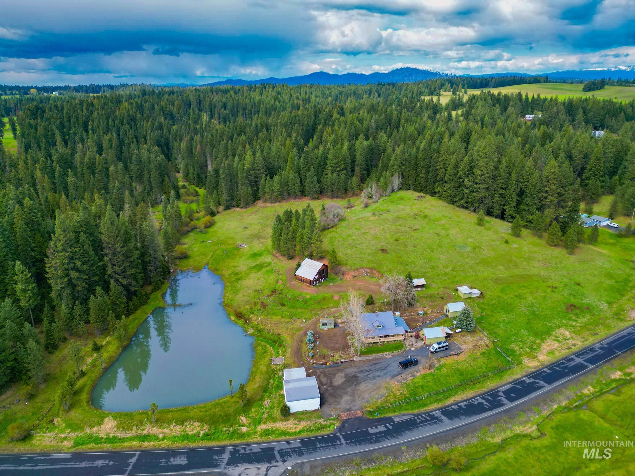 1995 Glenwood Road Kamiah, ID 83536 - Photo 38 of 38 Expansive property featuring a private pond, mature tree line, and a paved road frontage