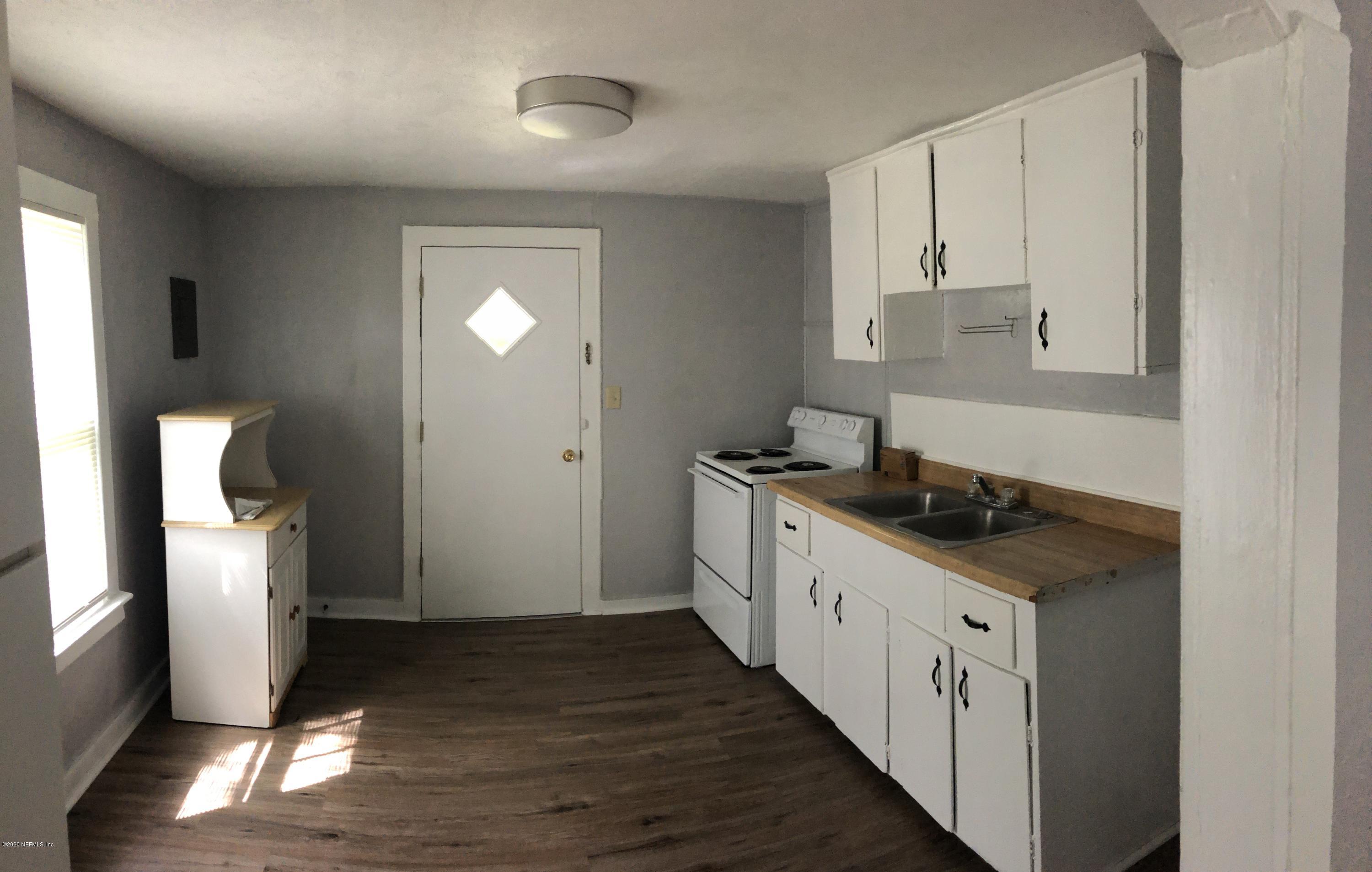 524 St Clair Street Starke, FL 32091 - Photo 8 of 20 a kitchen with a sink and wooden floor