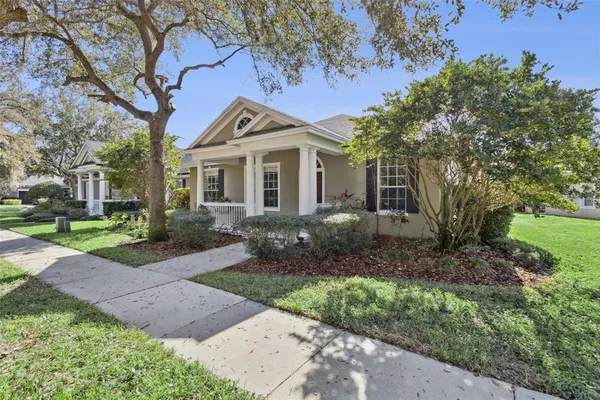 a front view of a house with yard and green space