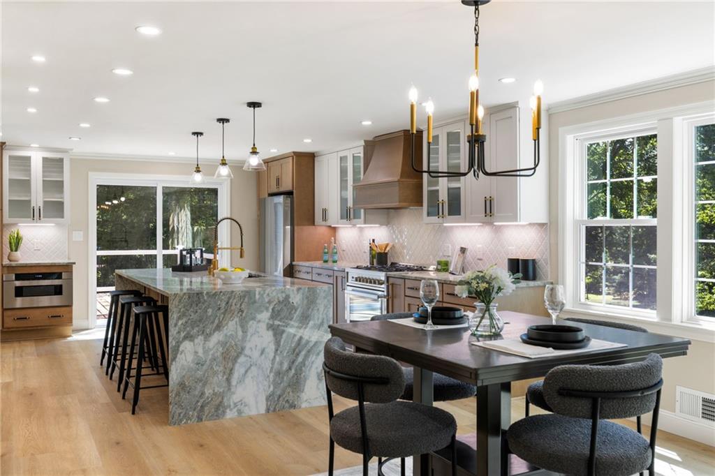 8241 Thompson Run Road Pittsburgh, PA 15237 - Photo 11 of 47 a view of a dining room and livingroom with furniture wooden floor a chandelier