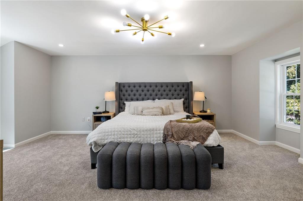 8241 Thompson Run Road Pittsburgh, PA 15237 - Photo 37 of 47 a bedroom with a bed and a chandelier