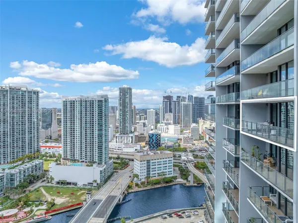 a bedroom with a bed and large window