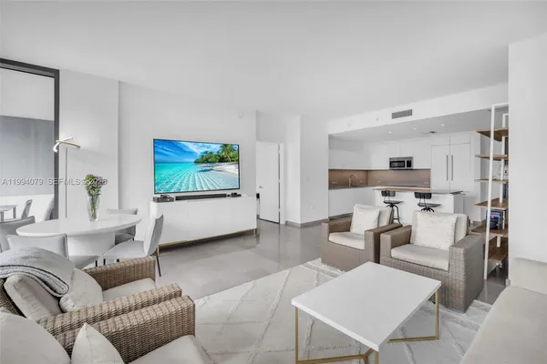 a view of a balcony with dining table and chairs