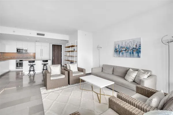 a living room with furniture and a large window