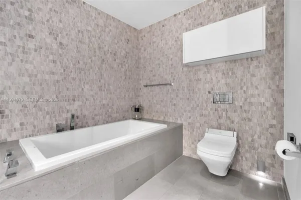 a living room with furniture and floor to ceiling windows