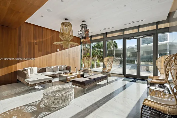 a kitchen with stainless steel appliances kitchen island granite countertop a stove top oven a dining table and chairs with wooden floor