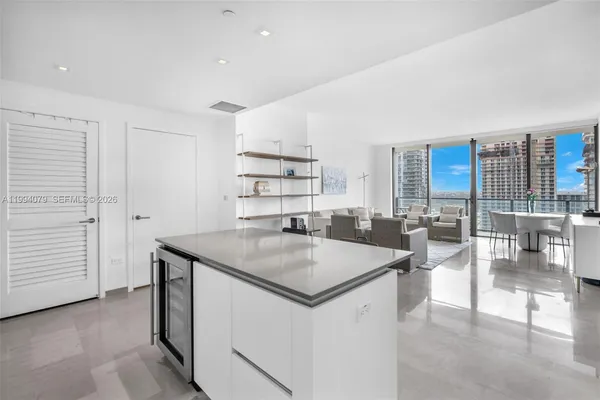 a dining hall with stainless steel appliances granite countertop a granite counter tops and a view of living room