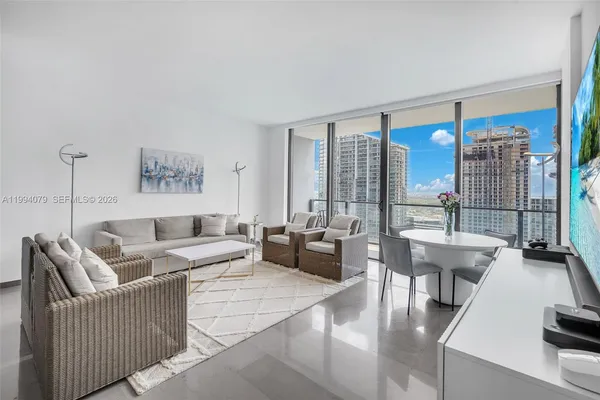 a living room with furniture and a large window