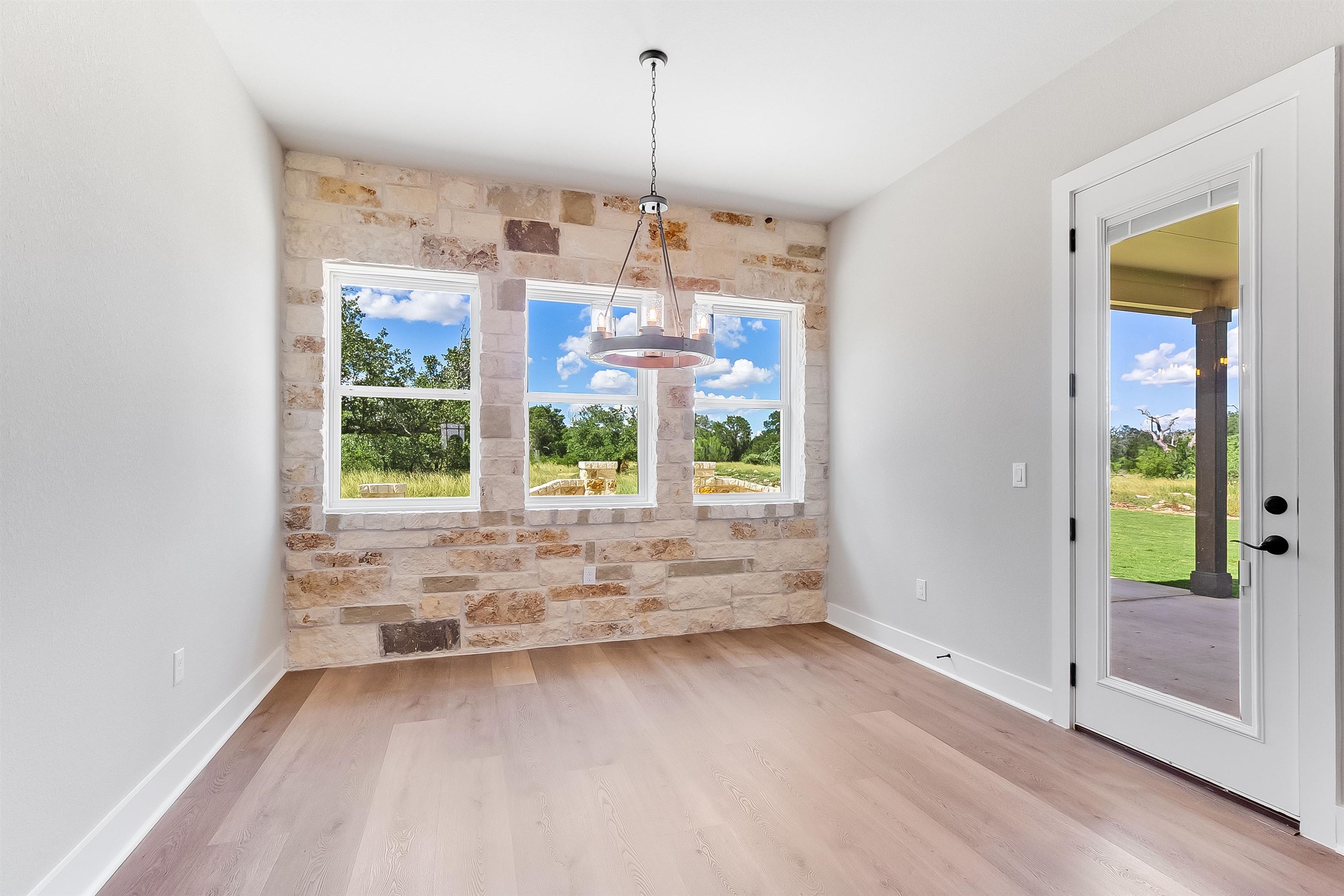 124 Draper Lane Bertram, TX 78605 - Photo 11 of 30 a view of a room with window wooden floor and windows