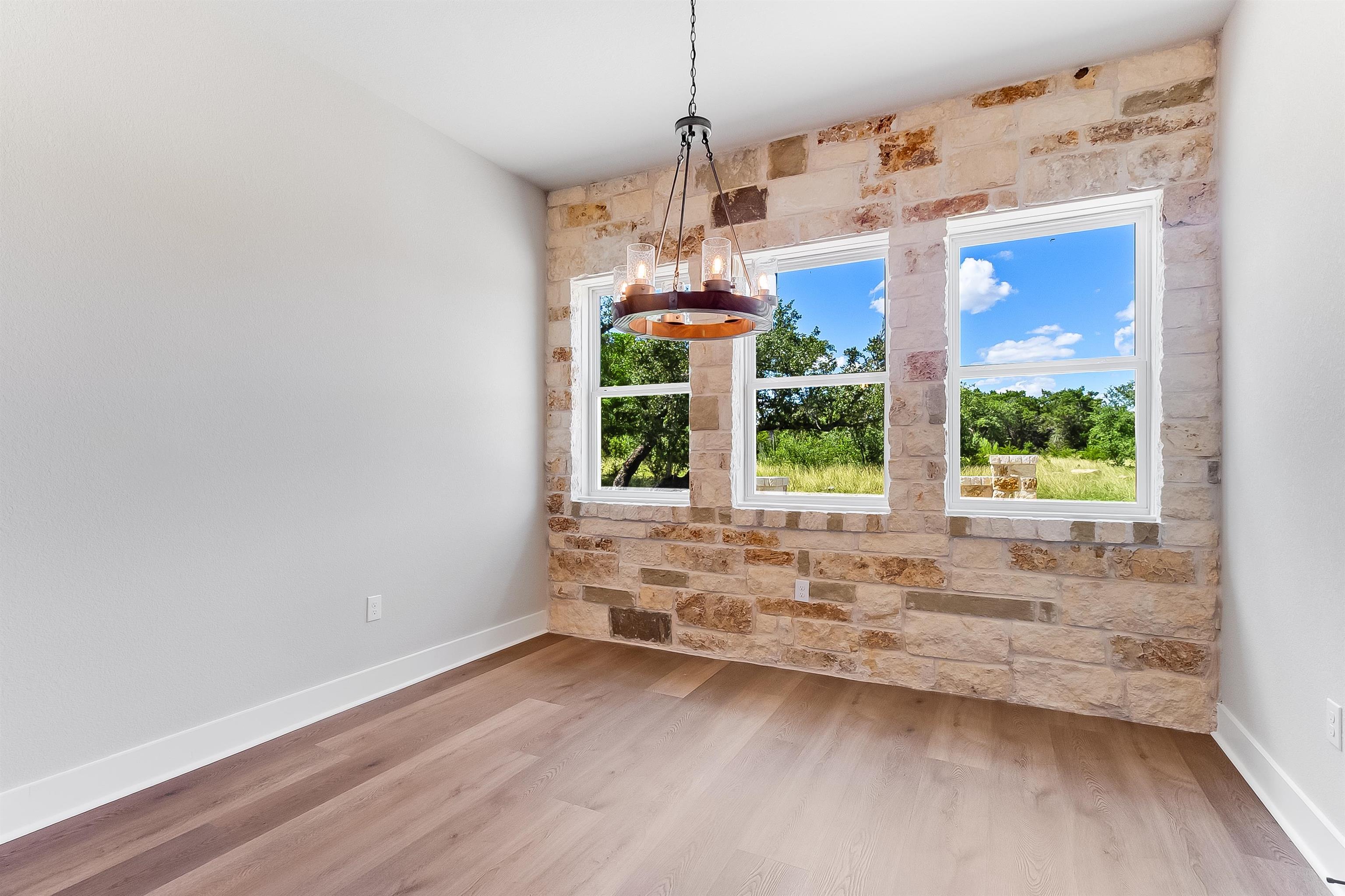 124 Draper Lane Bertram, TX 78605 - Photo 12 of 30 a view of a kitchen with wooden floor and natural light