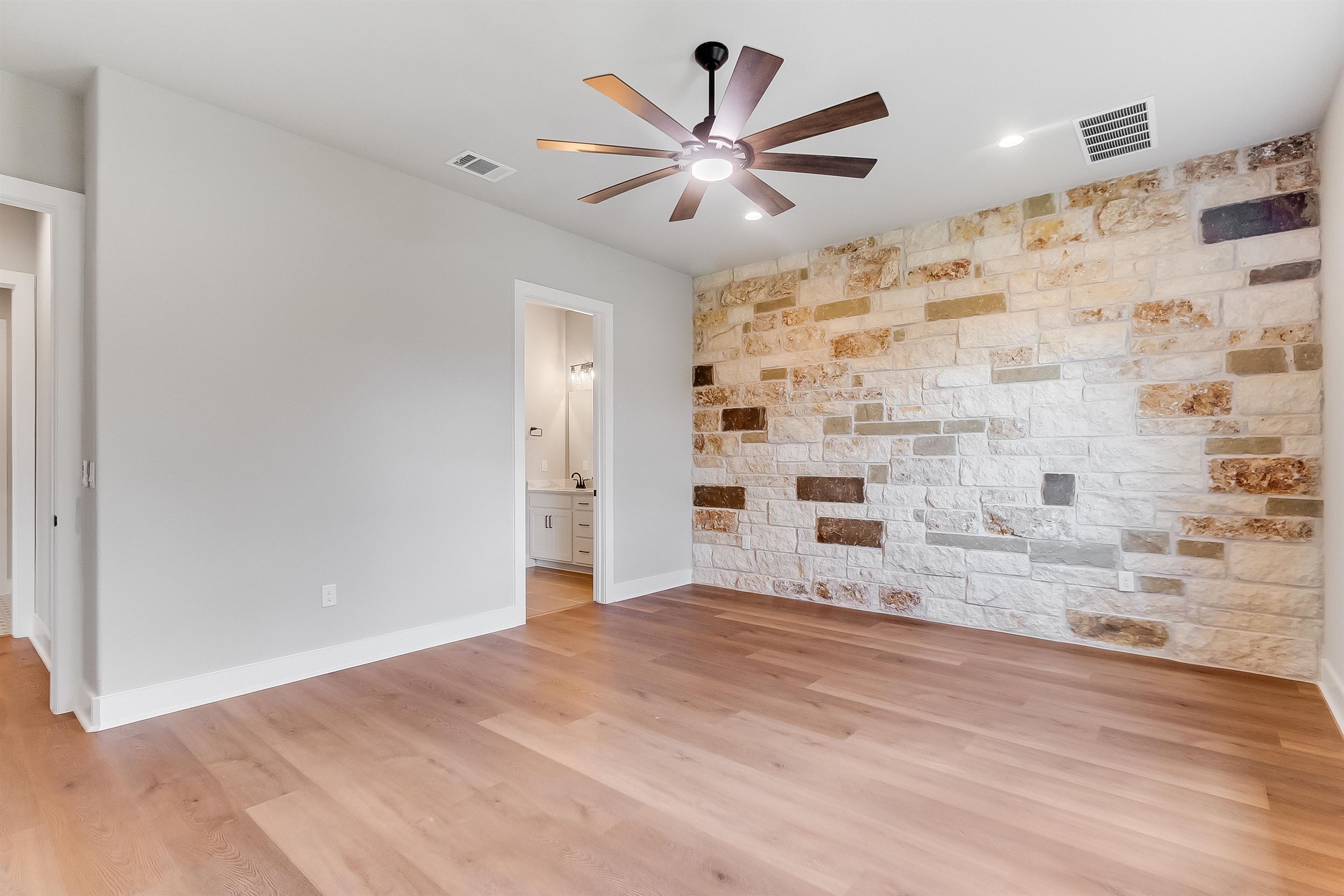 124 Draper Lane Bertram, TX 78605 - Photo 14 of 30 a view of a livingroom with a ceiling fan wooden floor and a ceiling fan