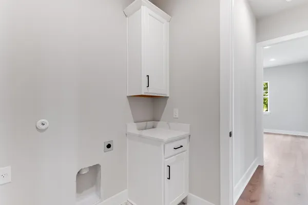 a bathroom with a granite countertop sink and white cabinets