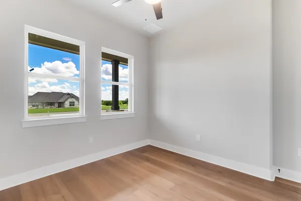an empty room with windows and closet