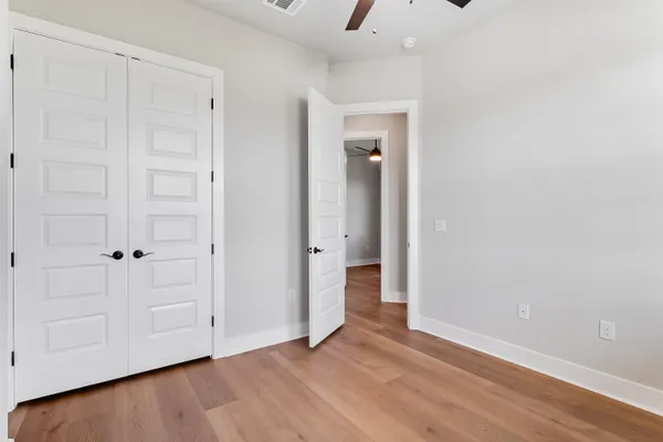 a view of an empty room and closet area