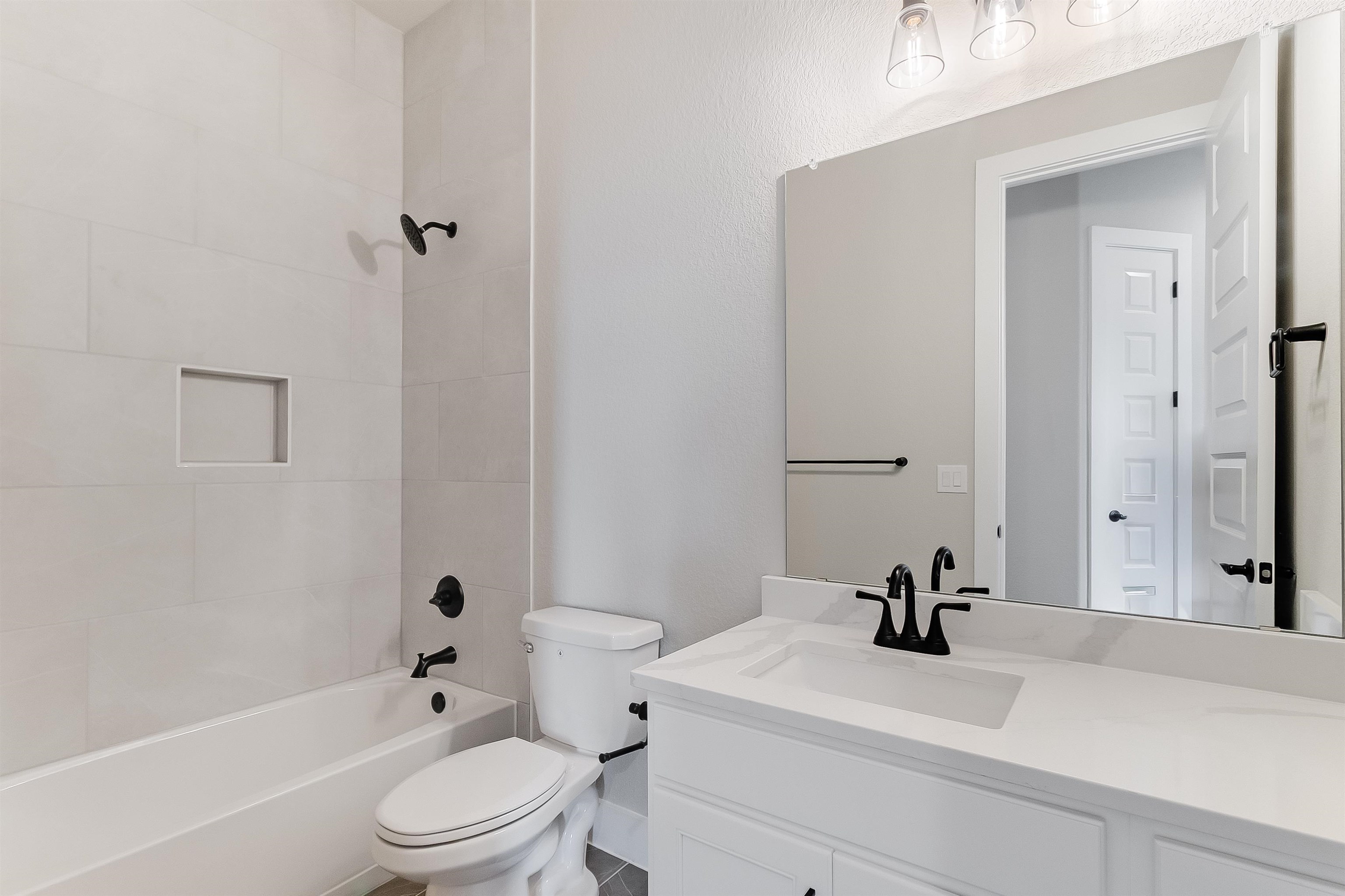 124 Draper Lane Bertram, TX 78605 - Photo 27 of 30 a bathroom with a sink a toilet and shower