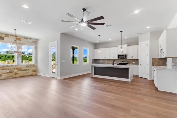 a view of kitchen with sink and wooden floor