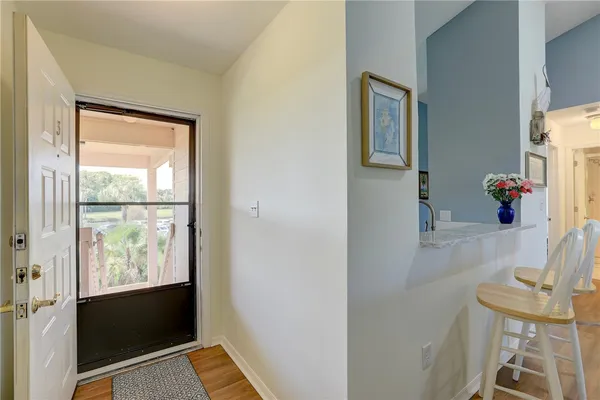 a view of hallway with furniture and a window