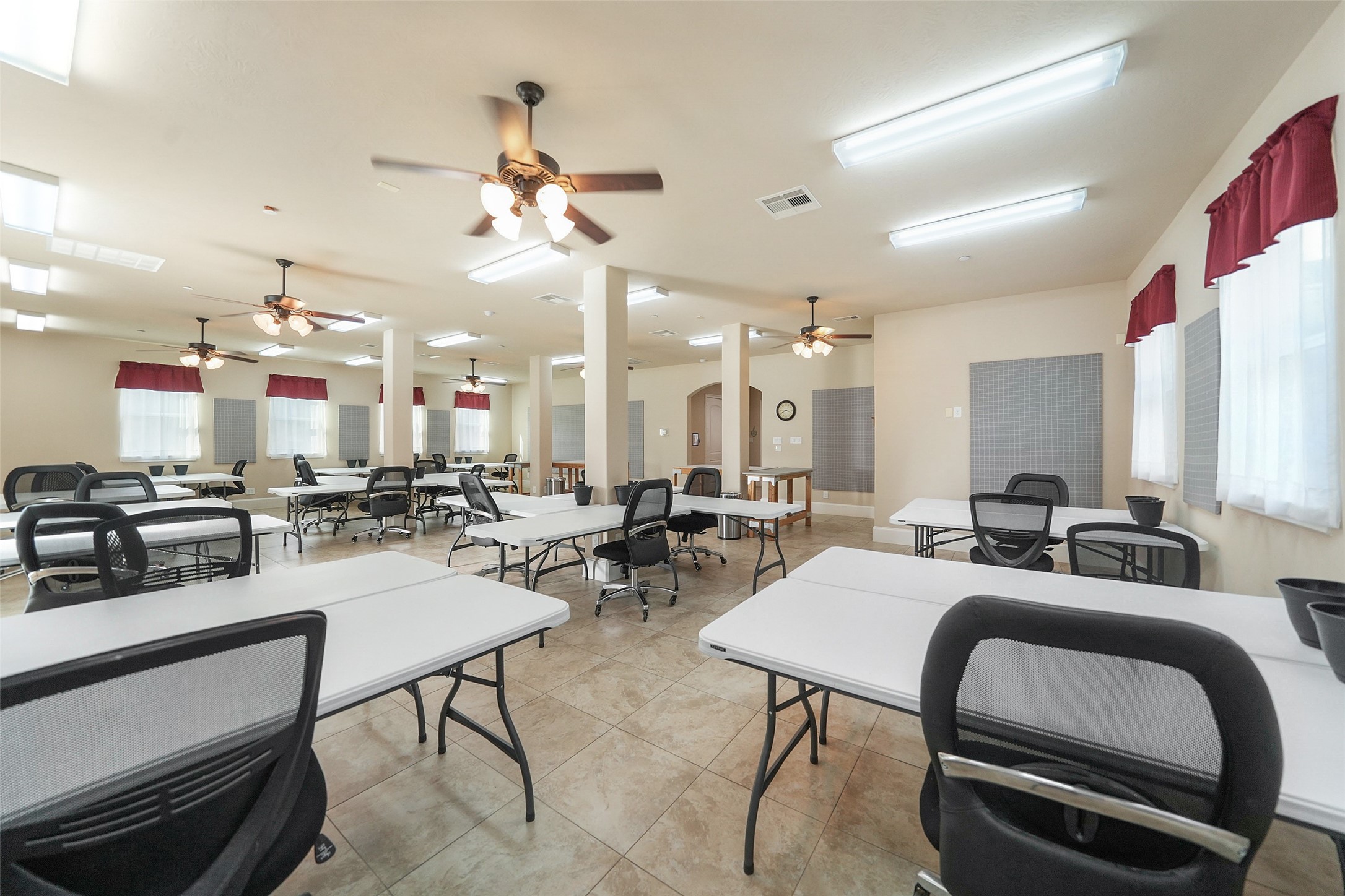 26250 A Riley Road Waller, TX 77484 - Photo 39 of 50 Expansive multi-purpose work room (~1,600 sq ft) with bright task lighting and fans—ideal for workshops or collaborative projects.