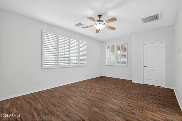 a spacious bathroom with double vanity and a mirror