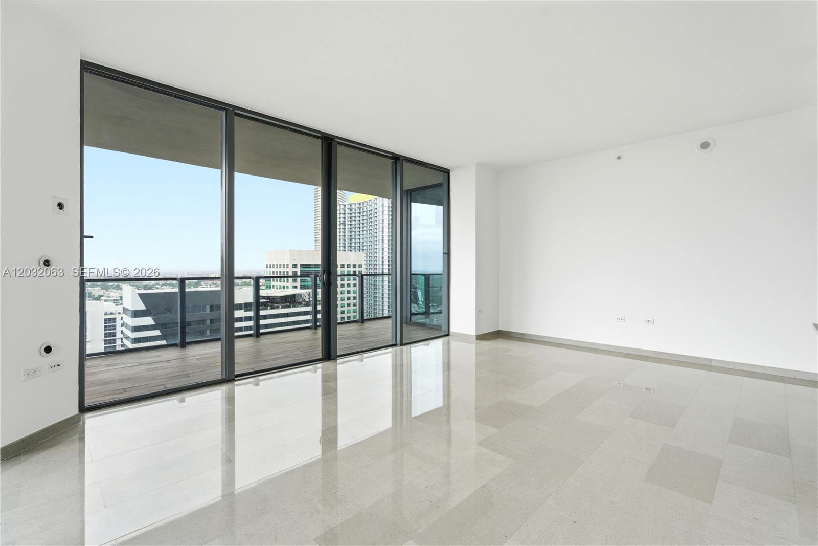 88 Southwest 7th Street, Unit 2302 Miami, FL 33130 - Photo 11 of 26 a view of an empty room with a large window