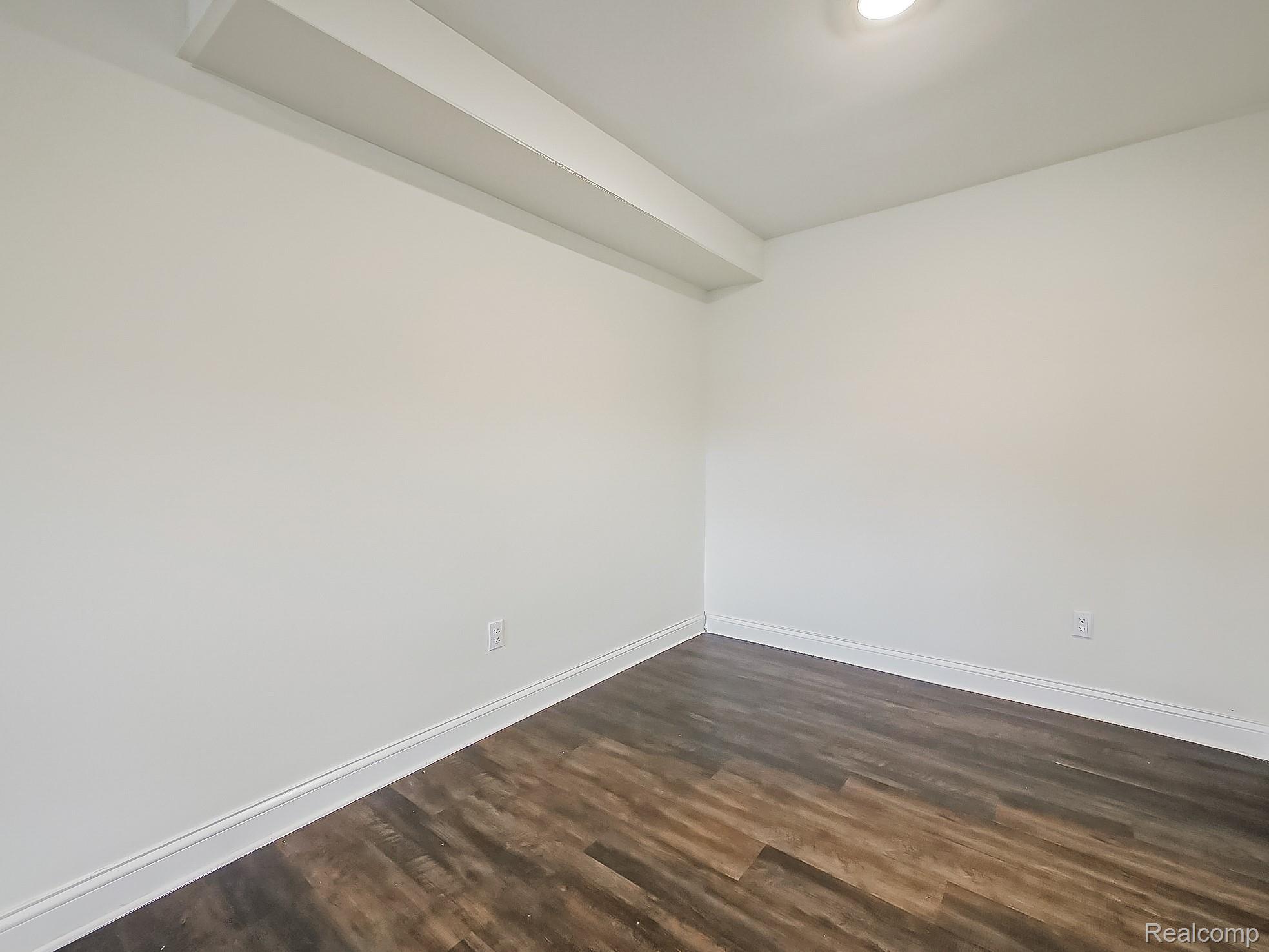 4905 South Crooks Road Royal Oak, MI 48073 - Photo 12 of 28 Spare room featuring baseboards and dark wood finished floors
